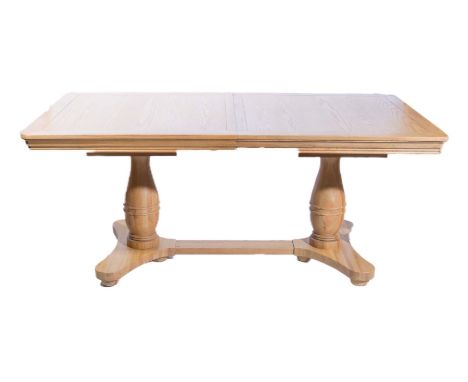 A modern light oak extending dining table, rectangular top, rounder corners, moulded edge, on twin baluster turned columns, i