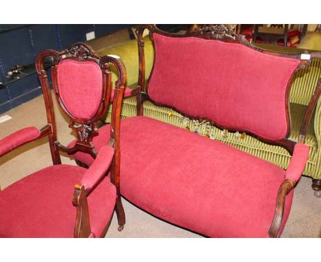 VICTORIAN MAHOGANY FRAMED SETTEE AND ELBOW CHAIR
each with pierced back and upholstered in ruby red dralon, over cabriole for