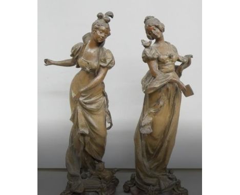 A pair of French Art Nouveau bronze spelter figures of ladies, on rouge marble socles, 30cms h