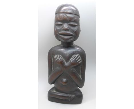 A carved African tribal art figure, possibly East Africa, 20cms h