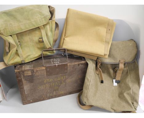An ammunition box, with army issue rucksack with tarpaulin and a shoulder bag