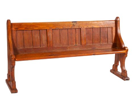 A pair of pine pews, in Reformed Gothic taste, circa 1900; with rectangular panel backs, the shaped sides cut with cusped Got