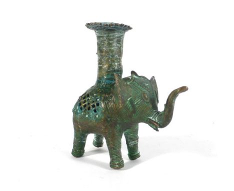 A cast metal candlestick, the base in the form on a standing elephant, h. 10 cm   CONDITION REPORT:  Poor quality 