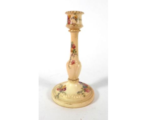 An Edwardian Royal Worcester blush ivory candlestick of silver shaped form, decorated with roses and flowering shrubs, pdcm 1