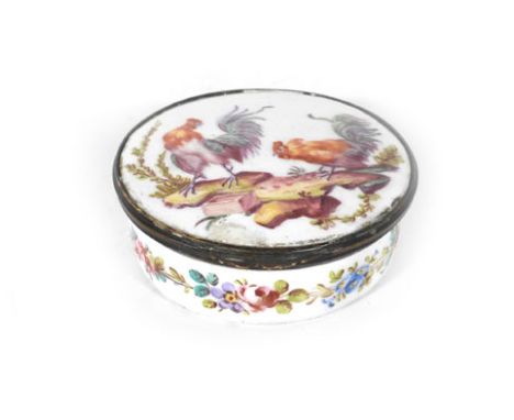 An 18th century French enamel patch box and cover of circular form, the cover painted with a pair of cockerals within a folia