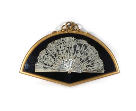 A 19th century mother-of-pearl and lace hand fan in a gilt presentation case, w. 67 cm   CONDITION REPORT:  some fading to la