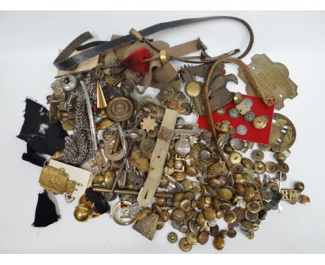 A large quantity of buttons, badges and metal helmet and uniform fittings