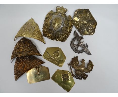 A quantity of metal helmet plates and identification plates 