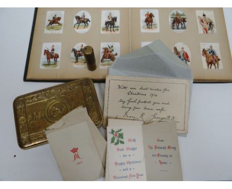 A Princess Mary 1914 Christmas tobacco tin containing enveloped Christmas card with cipher together with a trench art cigaret