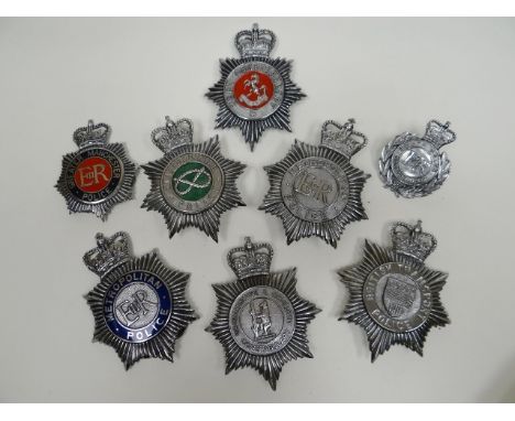 Eight police helmet plates 
