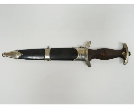 A German Third Reich Nazi NSKK dagger with RZM 1939 marking on blade with motto in scabbard eagle swastika motif missing from