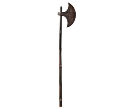 An Indian axe, heavy steel head with crescent shaped blade and incised decoration inhabited by a fish and a horse; bamboo haf