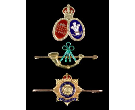 Three sweetheart brooches: The Hampshire Regiment, enamelled and stamped '15ct'; a light infantry stringed bugle, enamelled a