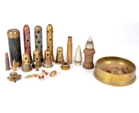 A collection of miscellaneous ordnance relics, including primer tubes, inert projectiles (some showing clear evidence of havi