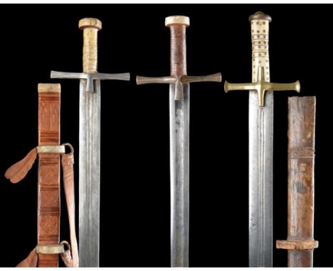 λ&nbsp;Three Sudanese swords (kaskara), the first with broad multi-fullered blade 35 in., long flaring quillons and short lan