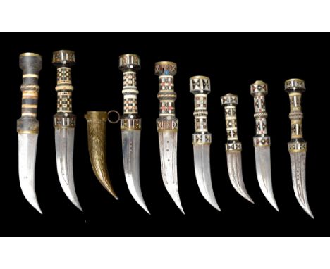 λ&nbsp;Eight Syrian daggers (jambiya), each with a stout curved blade, exhibiting various combinations of narrow fullers and 