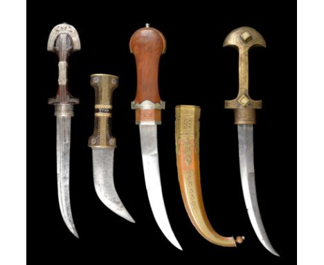 A collection of four daggers (jambiya), comprising: a Moroccan example with multi-fullered blade, white metal mounted wooden 