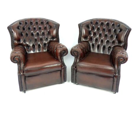 Pair of Chesterfield style armchairs, chestnut brown button leather upholstery, brass tack trim (2)