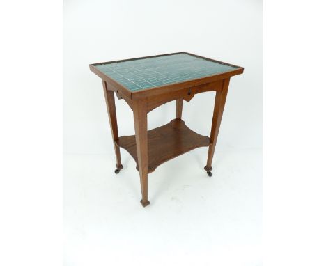 Arts & Crafts table in the manner of Liberty, oak frame, turquoise ceramic tile top, tapering box legs supporting shaped unde