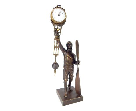 Novelty mantel clock, bronzed aviator figure of a WWI airman holding propeller, overall 31cm h