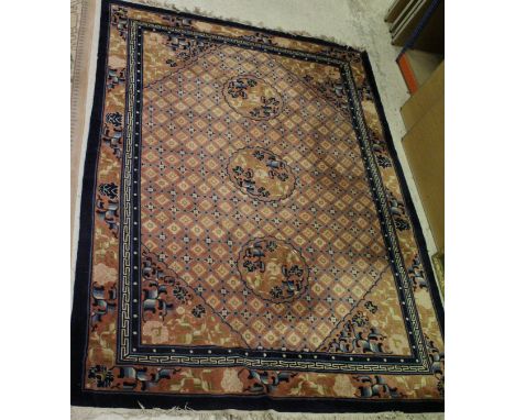 A Chinese superwash silk carpet, the central panel set with floral and lattice decoration on a salmon pink ground within a st