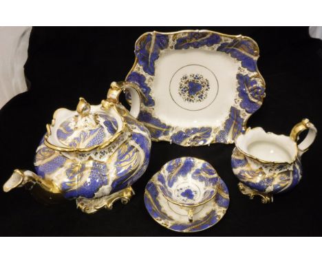 A 19th Century Rockingham style tea set, blue and gilt decorated, comprising teapot, cream jug, two dishes, one side plate, n