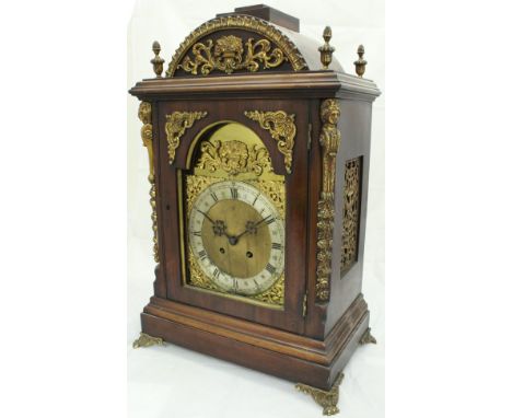 A Continental walnut cased mantle clock, the eight day movement with brass arched dial, the silvered chapter ring with Arabic