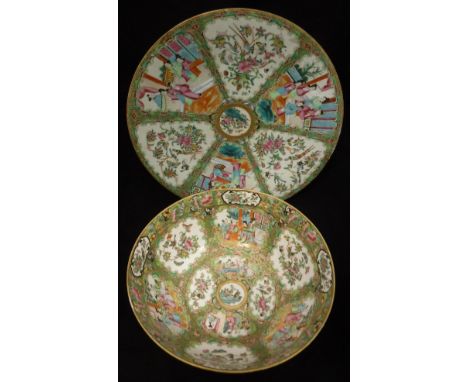 A 19th Century Cantonese famille-rose bowl and charger, each decorated with panels of figures and panels of flowers amongst b