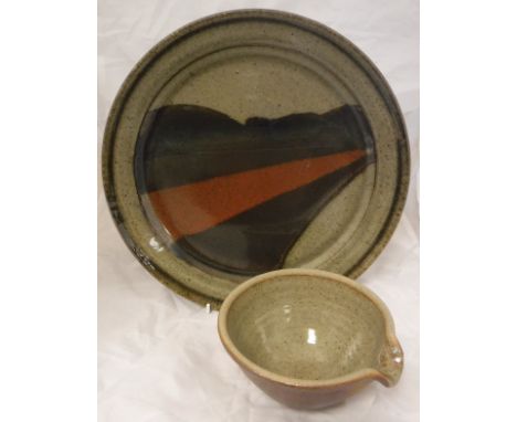 A John Leach Studio Pottery plate on a beige ground with brown red and brown striped flash, together with a John Leach lipped