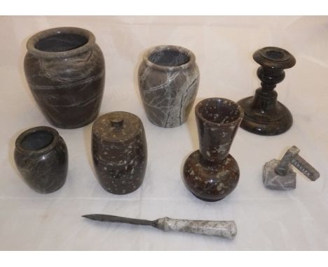 A collection of Serpentine wares comprising a candlestick, a thistle shaped vase, three pots, a lidded barrel, paperknife and