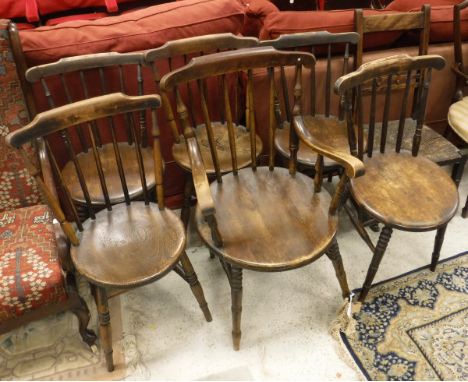 A Harlequin set of six stick back beech and elm kitchen chairs to include one carver, together with an elm and rush seated ro