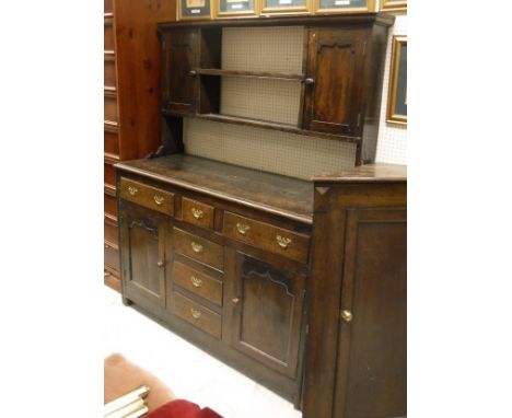 A 19th Century oak dresser, the plain top with moulded edge over three frieze drawers and a bank of three drawers, flanked by