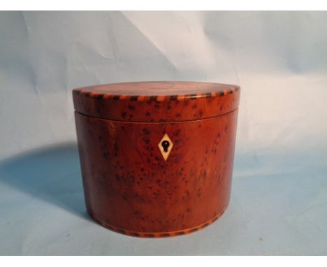 A George III oval tea caddy inlaid with a shell. H12cm
