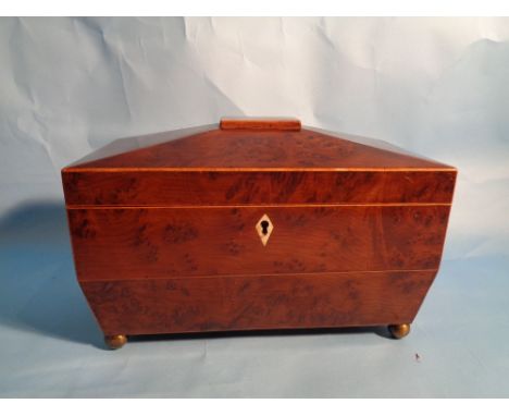 A George III sarcophagus shaped yew wood tea caddy with lionmask handles.  H16cm W29cm D14cm