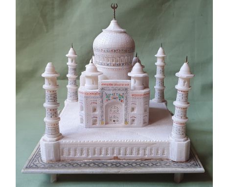 An alabaster model of the Taj Mahal, having carved, inlaid &amp; painted details, 9".
