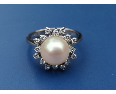 A pearl &amp; diamond set cluster ring on 750 white metal shank.  Finger size L.
