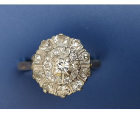 A diamond target cluster ring on 18ct shank.  Finger size P.