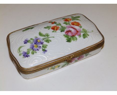 A continental gilt metal mounted porcelain trinket box, decorated with polychrome flowers and bianco sopra bianco, crude inte
