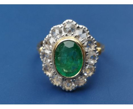 An emerald &amp; rose cut diamond oval cluster ring on 750 shank.  Finger size M.