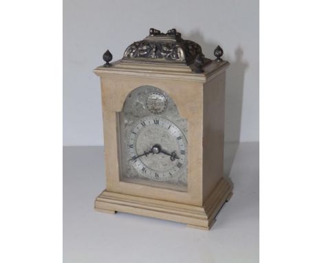 A 20thC bracket style mantel clock in limed wood case by Canham of London, 7" high excluding handle.