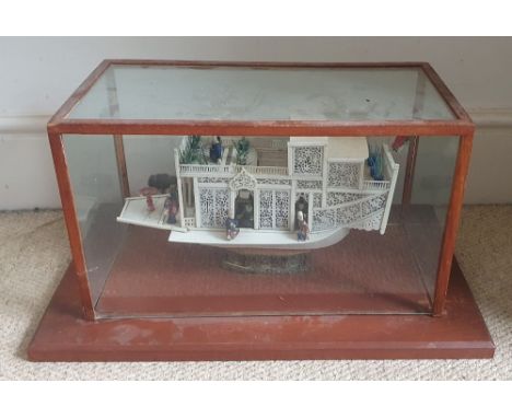 A 19thC Chinese bone model of a house boat junk, 13.4" across excluding glazed wooden case.