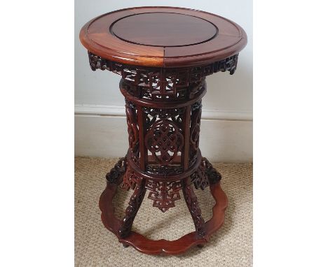 A Chinese carved wood circular pedestal table on openwork column to splayed base, 16" diameter.