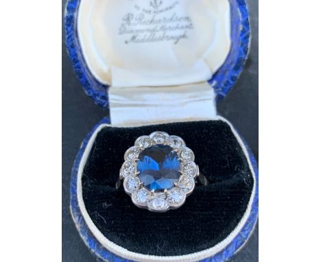 A certified natural colour change 3.12 carat Sri-Lankan sapphire &amp; diamond oval cluster ring set in white metal, accompan