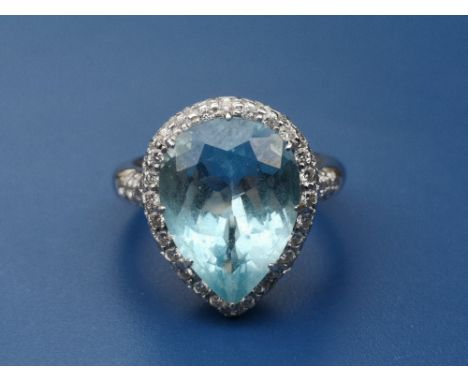 An aquamarine &amp; diamond set pear shaped cluster ring in 18ct white gold, the claw set aquamarine weighing approximately 6