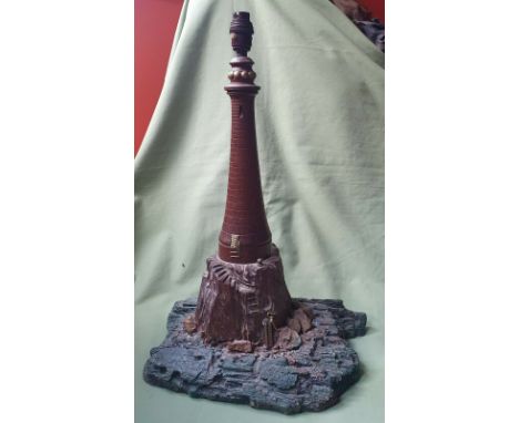 A large carved wooden lighthouse table lamp on naturalistic 'rocky' base, 19" high.