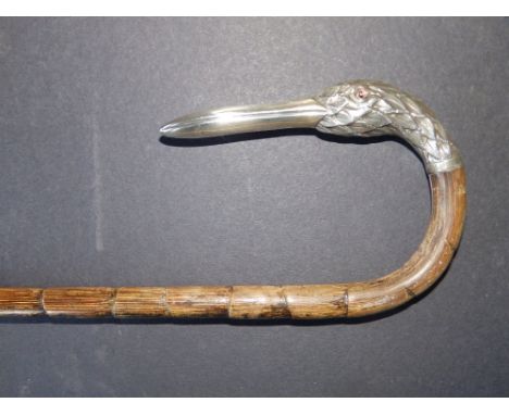 An early 20thC walking stick with silver duck head handle (one glass eye missing) - London marks for 1912,  37"  - a/f.