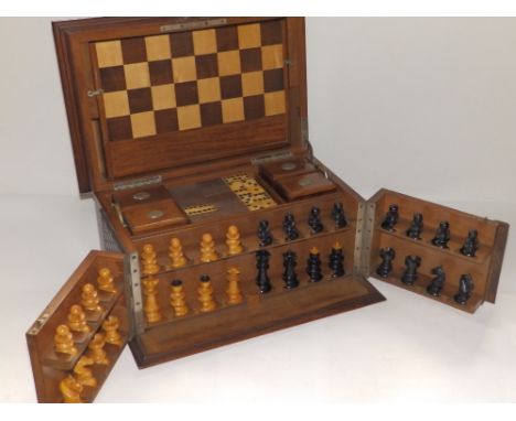 A late Victorian  games compendium, having hinged top and a pair of front doors, the fittings including dominoes, chess &amp;