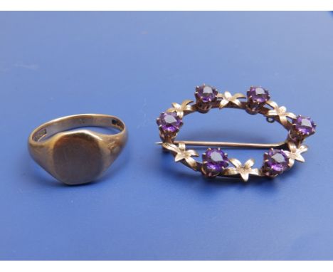 An amethyst set open oval 9ct brooch, 1.4" and a 9ct gold signet ring. (2).