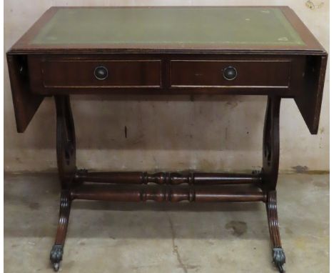 20th century mahogany drop leaf sofa table with green leather effect insert, stretchered supports and brass claw feet. Approx
