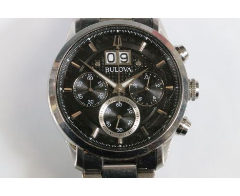 Bulova Sutton chronograph wrist watch having a black face with three subsidiary dials and large date aperture to twelve. Set 